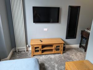 a living room with a tv and a coffee table at The Chelsea in Llandudno