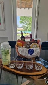 um cesto de comida numa mesa com copos de vinho em Casa Koya- Luxury house in the countryside 