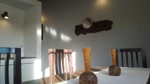 a dining room table with vases and a mirror on the wall at Departamento Independiente con Terraza in La Cieneguita +28 photos