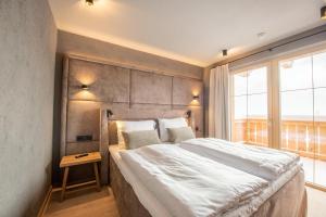 Postel nebo postele na pokoji v ubytování Filzsteinresort Wohnungen Top 7