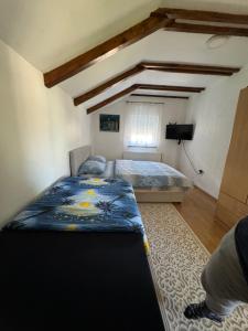 a bedroom with a bed and a television in it at Apartments Aida in Bihać