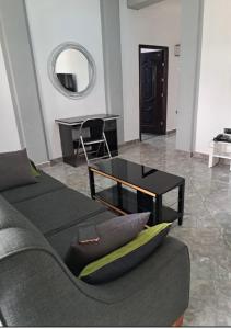 a living room with a couch and a table at BAFFOUR APARTMENTS in Adiebaba