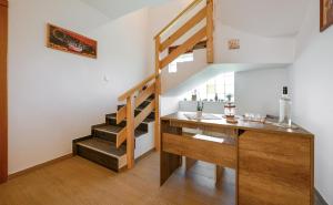 a staircase in a room with a desk and a stair case at B&B Plitvica Falls House in Plitvica selo