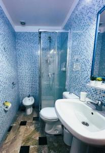 y baño con aseo, lavabo y ducha. en Mirage Mer B&B en Catania