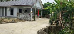 a small house with a driveway in front of it at Homestay BONDA 2 in Pasir Mas
