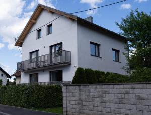 a white house with a balcony at Residence Black&White in Ljubljana