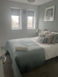 1 dormitorio blanco con 1 cama grande y 2 ventanas en The Serlio Baroque Court Apartment en Newport