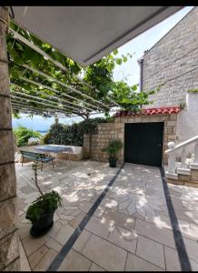 a patio with a green door and a table at GreenGarden in Dubrovnik +14 photos