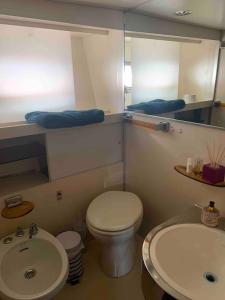 a bathroom with a toilet and a sink at NUIT EXCEPTIONNELLE SUR UN SUPERBE BATEAU Yacht ! in Empuriabrava +9 photos