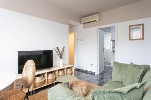 a living room with a couch and a tv at 3 Bdr Apt In Cornella 5 Mins Form The Metro in Cornellà de Llobregat