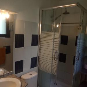 a bathroom with a shower and a toilet and a staircase at Une terrasse pleine vue mer in Le Gosier