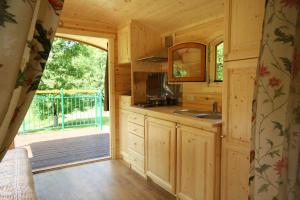 an interior view of a kitchen in a tiny house at Les Roulottes de la Dordogne in Champagnac