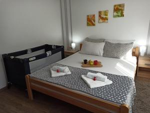 a bedroom with a bed with two towels and fruit on it at Kuća za odmor-Aleksandra in Divčibare +59 photos