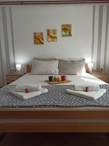 a bed with a tray of fruit on top of it at Kuća za odmor-Aleksandra in Divčibare