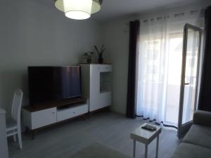 a living room with a large flat screen tv at A part hn in Herceg-Novi +2 photos