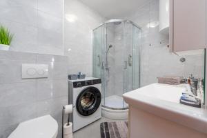 a bathroom with a washing machine in a shower at Apartment Matea with terrace in Zadar