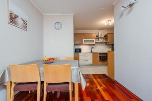 a kitchen and dining room with a table and chairs at Apartment Matea with terrace in Zadar