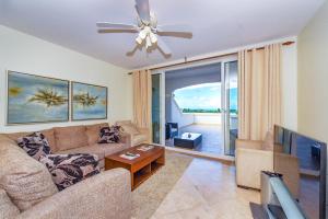a living room with a couch and a ceiling fan at Hotel La Vista Azul in Turtle Cove