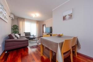 a living room with a table and a couch at Apartment Matea with terrace in Zadar +21 photos