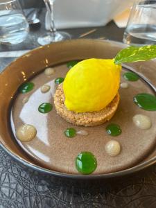 a dessert with a lemon on a plate at La Canotte in Saint-Julien-en-Born