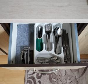 a drawer filled with utensils on a table at La Moieciu pe Deal in Moieciu de Jos