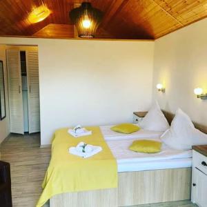 a bedroom with two beds with towels on them at Chalet Tinelu Brașov Săcele in Săcele