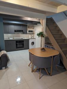 a kitchen with a dining room table and a staircase at Appartement 4 personnes bord mer in Yves