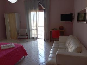 a living room with a couch and a tv at millennium holiday in Castellammare del Golfo