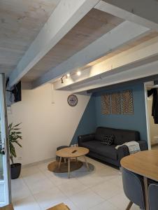 a living room with a couch and a table at Appartement 4 personnes bord mer in Yves +15 photos