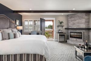 a bedroom with a large bed and a fireplace at Candle Light Inn in Carmel