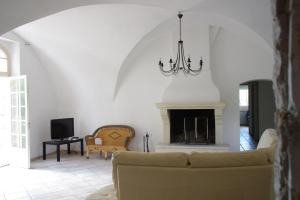 a living room with a couch and a fireplace at MOULIN SAINT ETIENNE in Bédarieux