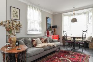 a living room with a couch and a table at Marners Rock No 1 in Fowey