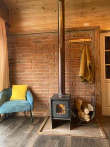 a brick wall with a wood stove in a room at Hostal Dos Volcanes in Malalcahuello