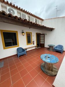 a patio with a table and chairs in front of a house at Casa da Moura in Moura
