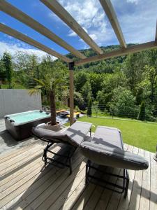 的住宿－Lelis Alpenloft - Bergchalet in Halden，一个带桌椅的甲板和一个游泳池
