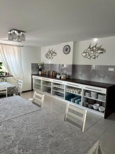 a kitchen with a table and chairs in a room at Rodart Morski in Sztutowo +63 photos