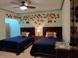 A bed or beds in a room at HOTEL CASA LIMON