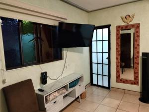 A television and/or entertainment centre at HOTEL CASA LIMON