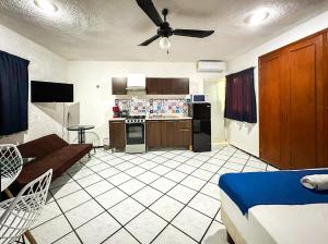 a kitchen and living room with a ceiling fan at Loft Martini - en excelente zona con alberca in Mérida