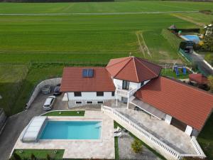una vista aérea de una casa con piscina en Villa 5*, 15 personnes, Piscine à 20 min de Genève en Juvigny