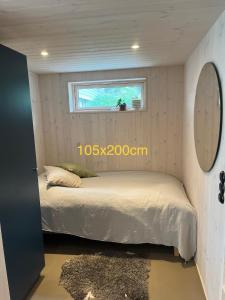 a bedroom with a bed in a small room at Mysigt attefallshus med närhet till stad och hav in Västra Frölunda