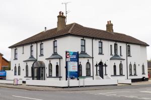 a white building with a sign in front of it at Victoria Apartments in Skegness
