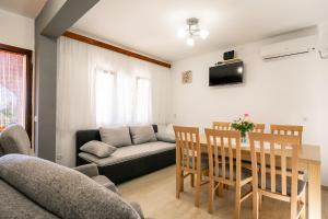 a living room with a table and a couch at Villa Franciska in Blato