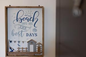 a sign that reads beach days are the best days at Victoria Apartments in Skegness