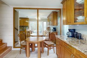 a kitchen with wooden cabinets and a table and chairs at Kuapa Isle Gem Unit 419 in Honolulu
