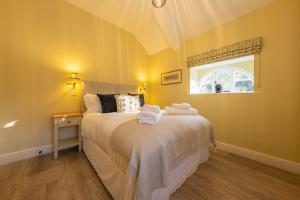 a bedroom with a large bed and a window at The Coach House R 6 in Ringstead