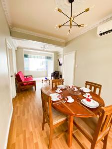 a dining room with a wooden table and chairs at Mjs On the Savannahin Port of Spain, Port of Spain Corporation, Trinidad and Tob in Port-of-Spain