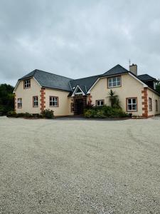 a large house with a driveway in front of it at Ashville Guesthouse in Westport