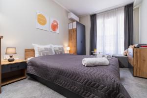 a bedroom with a large bed and a window at City Center Studio Apartments in Plovdiv