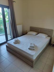 a bedroom with a bed with two towels on it at Argostoli bay view in Argostoli